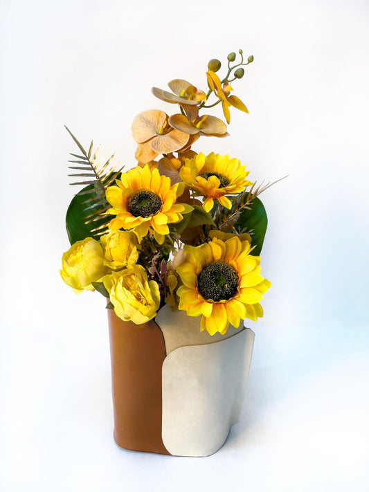 Artificial Floral Arrangement in a Leather Vase with Warm Yellow Tones